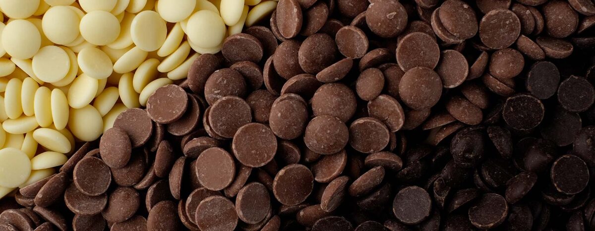 An arrangement of El Rey chocolate discs: white chocolate, milk chocolate, and dark chocolate